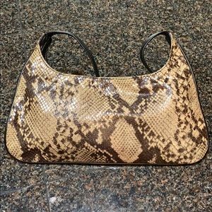 Snakeskin style w single strap w button closure.